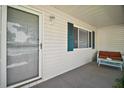 Cozy covered front porch with a seating area, perfect for relaxing outdoors at 10347 Se 178Th Pl, Summerfield, FL 34491