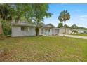 A single-story home with a well-kept lawn, palm trees and a screened-in garage at 11091 Sw 76Th Ter, Ocala, FL 34476