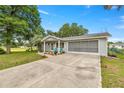 This home has a long driveway, and a screened-in garage to enjoy the outdoors at 11091 Sw 76Th Ter, Ocala, FL 34476