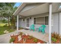 Inviting front porch with comfortable seating and charming landscaping detail at 11091 Sw 76Th Ter, Ocala, FL 34476