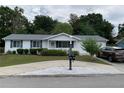 Charming single story home featuring manicured landscaping, decorative white stones and a well-maintained lawn at 11445 Sw 84Th Avenue Rd, Ocala, FL 34481