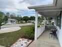 Inviting front porch with seating area overlooking the well-kept landscaping and the friendly neighborhood street at 11445 Sw 84Th Avenue Rd, Ocala, FL 34481