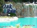 Water feature with community sign, creating an inviting and picturesque entrance to Oak Run at 11651 Sw 77Th Cir, Ocala, FL 34476