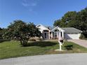 Inviting single-story home with a well maintained lawn, complemented by mature landscaping at 11651 Sw 77Th Cir, Ocala, FL 34476