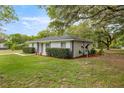 A cozy single-story home with green lawn and side view to the backyard at 13102 Se 101St Ave, Belleview, FL 34420