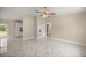 Bright living room with new white marble floors and neutral paint at 13102 Se 101St Ave, Belleview, FL 34420