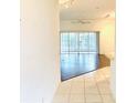 View of a bright living room with hardwood floors and sliding doors to a screened lanai at 1402 Arredondo Dr, The Villages, FL 32162