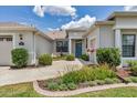 Inviting front entrance with a well-maintained garden, charming fountain, and bright blue door at 1427 Sw 161St St, Ocala, FL 34473