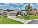 Charming single-story home with a well-manicured lawn, lush landscaping, and a two-car garage at 1427 Sw 161St St, Ocala, FL 34473