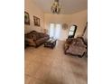 Elegant living room with tiled floors, decorative accents, and stylish furniture at 15011 Sw 61St Court Rd, Ocala, FL 34473