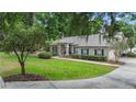 Charming home with a green lawn and landscaped front yard, complemented by lush surrounding trees at 1617 Se 29Th Ter, Ocala, FL 34471