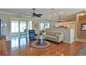Cozy living room boasts hardwood floors, neutral tones, and access to a screened-in lanai at 2550 Nw 55Th Avenue Rd, Ocala, FL 34482