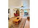 Open living room flowing into the kitchen, featuring hardwood floors and a comfortable layout at 3106 Silver Palm Dr, Edgewater, FL 32141