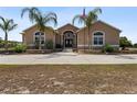 Lovely single story home featuring a long private driveway and lush landscaping at 4725 County Road 121D, Wildwood, FL 34785