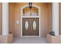 Elegant front door with decorative glass, sidelights, and transom window at 4725 County Road 121D, Wildwood, FL 34785