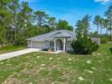 Charming single-Gathering home with an attached garage and a beautiful landscaped front yard at 5195 Sw 128Th Street Rd, Ocala, FL 34473