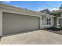 Attached garage with a concrete driveway and a manicured front yard at 5195 Sw 128Th Street Rd, Ocala, FL 34473