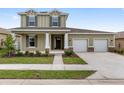 Two story home with a 2 car garage, front porch with columns and landscaping at 5894 Sw 77Th Ct, Ocala, FL 34481