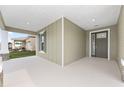 Spacious front porch with green siding at 5894 Sw 77Th Ct, Ocala, FL 34481
