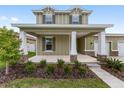 Welcoming front porch with stone accents, columns and landscaping at 5894 Sw 77Th Ct, Ocala, FL 34481