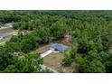An aerial view showcases this attractive home nestled among lush trees and situated on a sprawling lot at 7299 Sw 202 Ct, Dunnellon, FL 34431