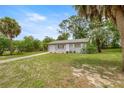 Charming single-story home featuring a one car garage and a well-maintained front yard with mature trees at 8449 Sw 105Th Pl, Ocala, FL 34481