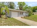 Well-maintained single-story home featuring an attached garage and green front lawn at 8449 Sw 105Th Pl, Ocala, FL 34481
