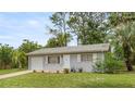 Inviting single-story home with attached garage, complemented by a well-kept lawn at 8449 Sw 105Th Pl, Ocala, FL 34481