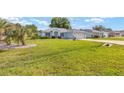 Well-maintained single-story home showcasing a lush green lawn and mature landscaping at 8722 Sw 60Th Cir, Ocala, FL 34476