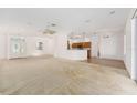 Open-concept living room showcasing natural light, neutral walls, and a partial view of the kitchen at 9649 Sw 90Th St, Ocala, FL 34481