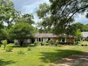 Charming single-story home surrounded by lush greenery and mature trees on a sun-drenched lot at 9850 Sw 191St Ave, Dunnellon, FL 34432