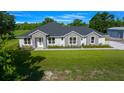 Attractive single-Gathering home featuring manicured lawn, stone accents, and an adjacent storage building at 1058 Se 59Th St, Ocala, FL 34480