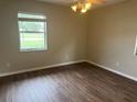 Well-lit bedroom with a ceiling fan, a window, and wood flooring at 10739 Se 44Th Ter, Belleview, FL 34420