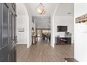 Inviting foyer featuring hardwood floors, arched doorways, and a view into the living room at 15 Sunrise Dr, Ocala, FL 34472