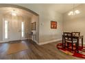 Inviting entryway with light wood-look floors, high ceilings and decorative table with accent mirror at 1690 Sw 158Th Ln, Ocala, FL 34473