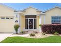 Close up of the front entrance, featuring a decorative security door, manicured lawn and mature shrubs at 1690 Sw 158Th Ln, Ocala, FL 34473