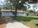 Inviting single-story home with a concrete driveway and green yard, offering comfortable living at 17315 Se 18Th St, Silver Springs, FL 34488