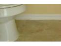 Close-up of a pristine white toilet and neutral-toned tile flooring at 1754 Sw 160Th Pl, Ocala, FL 34473