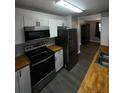 Modern kitchen featuring stainless steel appliances, sleek cabinets, and butcher block countertops at 1809 Sw 29Th Ter, Ocala, FL 34474