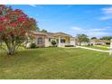 Inviting front exterior showcasing lush lawn, mature landscaping, and charming architectural details at 2158 Nw 50Th Ave, Ocala, FL 34482