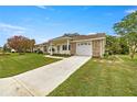 This home features a well-manicured lawn, a two-car garage, and an inviting front porch at 2158 Nw 50Th Ave, Ocala, FL 34482