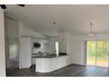 Open kitchen with sleek countertops, stainless steel appliances, and modern lighting at 227 Fisher Run, Ocklawaha, FL 32179