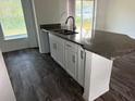 Kitchen island with granite countertop and undermount sink at 227 Fisher Run, Ocklawaha, FL 32179