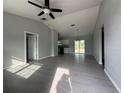 Spacious living room features recessed lights, tile floors and neutral paint, flowing into the kitchen area at 28 Bahia Pass Dr, Ocala, FL 34472