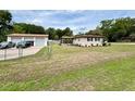 A quaint single-story home with a detached two-car garage in a spacious, grassy yard at 2848 Se 11Th St, Ocala, FL 34471