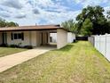 Exterior view of a house featuring a carport and a well-maintained lawn at 2848 Se 11Th St, Ocala, FL 34471