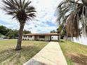 Inviting single-story home featuring a covered carport and a well-manicured lawn at 2848 Se 11Th St, Ocala, FL 34471