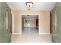 Bright foyer with tile flooring leading to a living area at 3950 Se 10Th Ln, Ocala, FL 34471