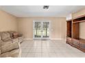 Spacious living room with tile floors and sliding glass doors to the backyard at 3950 Se 10Th Ln, Ocala, FL 34471