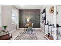Elegant home office featuring a decorative paneled accent wall, a work desk, and natural light at 4301 Sw 54Th Street Rd, Ocala, FL 34474